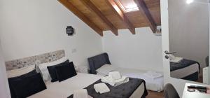 a room with two beds in a room with a door at Casa do Chafariz in Cercal +53 photos