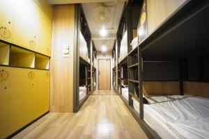 a corridor of a dorm room with bunk beds at BRB Hostel Bangkok Silom in Bangkok +39 photos