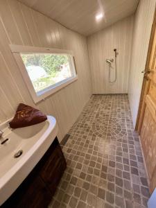 a small bathroom with a shower and a sink at La Bohème aux wallabies in Pajay