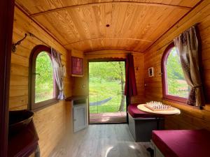 a small room with a table and two windows at La Bohème aux wallabies in Pajay