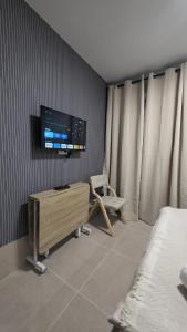 a bedroom with a tv on the wall and a chair at The Bubble in Madrid