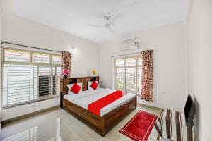 a bedroom with a bed and a large window at Hotel O Dream Marion in Bhubaneshwar