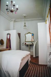 a bedroom with a bed and a table and a chandelier at Riad Tetuanía in Tétouan