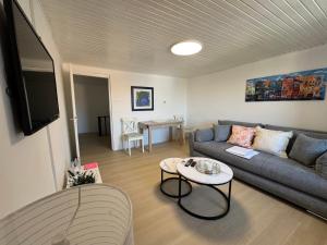 a living room with a couch and a table at Apartment BELLA in Karlobag