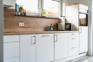 a kitchen with white cabinets and a sink at Seepark Goch-Kessel in Kessel