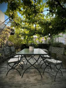 a table and chairs sitting under a tree at Il Palazzetto - La terrazza di Elia in Cividale del Friuli