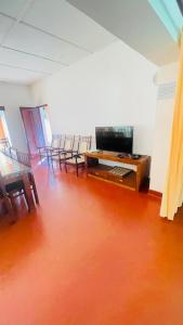 an empty room with chairs and a table with a television at Gal Bungalow in Elpitiya