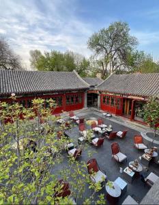 a building with a courtyard with chairs and tables at Atour Hotel Beijing Gulou Houhai - Free Night Snacks in Beijing