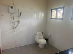 a bathroom with a toilet and a window at theorenda 002 in Koh Samui +23 photos