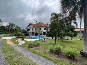 a house with a swimming pool in a yard at theorenda 002 in Koh Samui