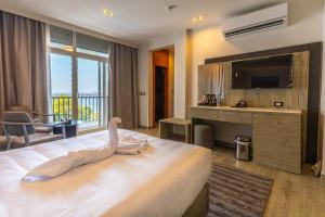 a hotel room with a large bed with a swan on it at Regency Nile Hotel Assuit in Al Ḩamrāʼ