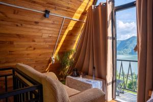 a room with a balcony with a view of the water at The Edge Villa & Retreat in Pokhara