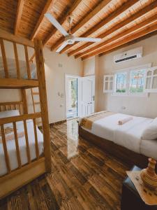 a bedroom with two beds and a ceiling fan at Slow Tunis in Tunis