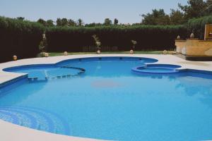 a large pool with blue water in a yard at Slow Tunis in Tunis
