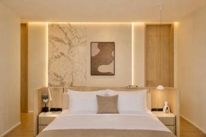 a bedroom with a large bed with white sheets at Le Da Villas 5BR Bang Tao Beach in Laguna Phuket +11 photos