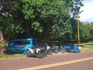 a group of motorcycles parked next to a blue bus at Lhady Roxy in Siquijor