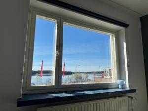 a window with a view of a body of water at Saimaa Design, lake view, AC, Wifi in Savonlinna