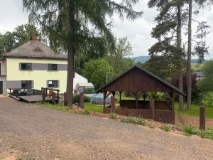 a building with a gazebo next to a house at VilaEva Adršpach Broumovsko in Ruprechtice