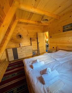 a bedroom with a bed in a wooden cabin at Cottage Magdalena in Žabljak
