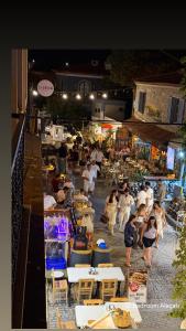 a group of people walking around a market at night at Bedroom Alaçatı in Alaçatı
