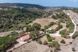 an aerial view of a farm with houses and trees at Residence Hotel Monte Ricciu Nuova Gestione in Alghero