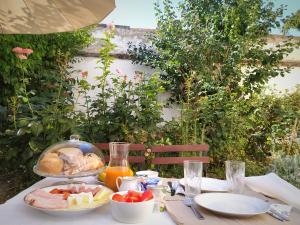 a table with a plate of food on it at Atelier Keszthely Center in Keszthely
