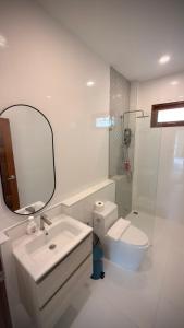 a bathroom with a sink and a toilet and a mirror at Canal Villa in Chaloklum +13 photos