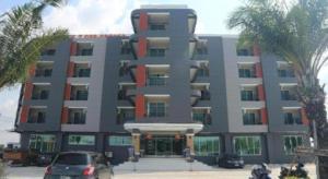a large building with cars parked in front of it at PJ PLACE in Ban Bang Samak
