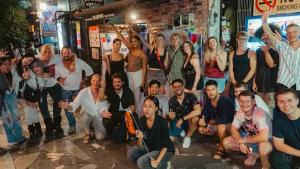 a group of people posing for a picture on a street at UNPLAN Shinjuku in Tokyo