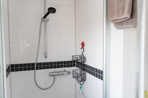 a bathroom with a shower with three shower heads at Lebensfreude in Goch +9 photos
