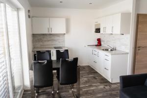 a kitchen with a table and chairs in a room at Lebensfreude in Goch