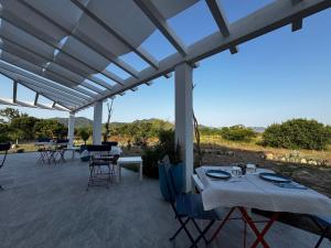 a patio with tables and chairs with a view at Tenuta Feraxi - Private Paradise in Costa Rei