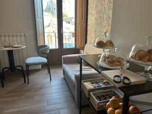 a living room with a couch and a table with bread at B&B La Casa Nel Borgo in Morano Calabro