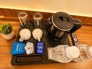 a tray with a coffee pot on top of a counter at HOTEL NEAR KASHI VISHWANATH VARANASI SHREE R-KRISHNA - wifi - Lift - FAMILY HOTEL in Varanasi