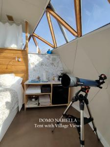 a camera on a tripod in a room with a bed at Mirador de Pideago in Bolea