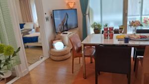 a dining room with a table and a tv at Daol in Seoul