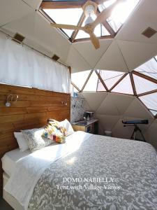 a bedroom with a bed in a room with skylights at Mirador de Pideago in Bolea +29 photos