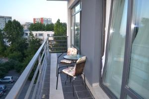 a balcony with a table and chairs on a balcony at City Park Residence in Constanţa