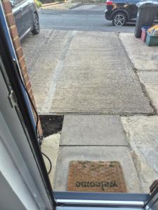 a view of a parking lot with a sign on the street at 2BR home in Twickenham in Hounslow