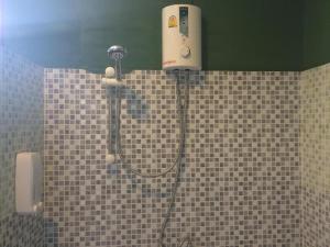 a shower in a bathroom with a blow dryer at Cha-Tinnie Hotel in Phra Ae beach +19 photos