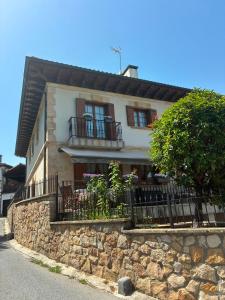 a house with balconies and a stone wall at Balentzenea Rural House in Lesaka