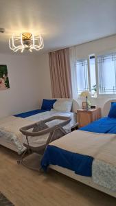 a bedroom with three beds and a chandelier at Daol in Seoul