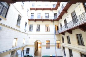 an empty hallway of an apartment building with two balconies at Budget Apartment by Hi5 - Október 6 Str 4 in Budapest