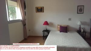 a bedroom with a bed and a window at Chambre d'hôtes à Juvignac in Juvignac