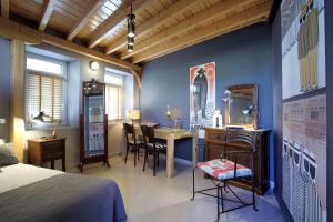 a bedroom with a bed and a table with chairs at eliamaria artistic house in Lefkada