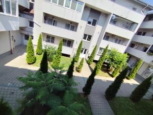 an apartment building with trees in front of it at Serana Home in Cisnădie