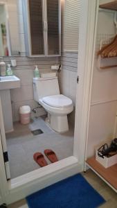 a bathroom with a toilet and a pair of slippers at Daol in Seoul +23 photos