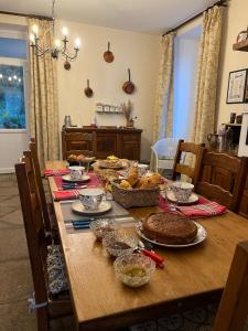 a wooden table with food on top of it at Le Manoir de Gourvinec in Saint-Nolff