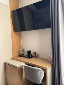 a desk with a chair in a room at FERHADIJA Apartments by Nejra in Sarajevo