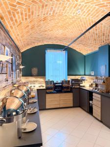 a large kitchen with wooden ceilings and counters at Hotel Benaco in Desenzano del Garda
